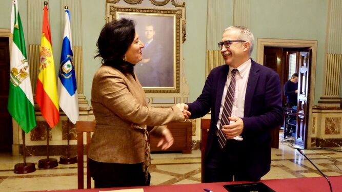 Esther Cumbrera y Joan Carles March se saludan tras la firma del convenio.