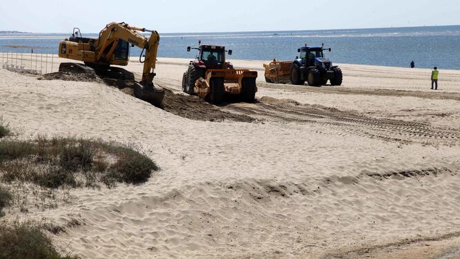Maquinaria en plena acción en la playa del Nuevo Portil en Cartaya