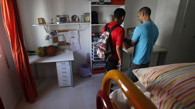 Un educador conversa con uno de los menores en una de las habitaciones del hogar de acogida.
