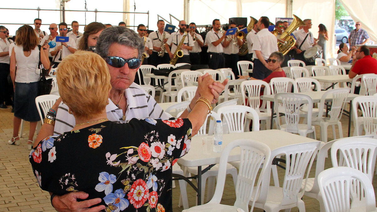 Una pareja baila en la carpa al son de la Banda Sinfónica Municipal de Huelva.