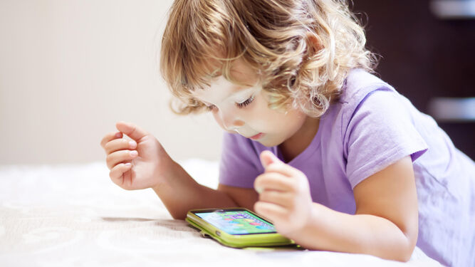 Una niña ve contenidos infantiles a través del móvil, algo que será ahora más seguro gracias al servicio 'Movistar Junior'.