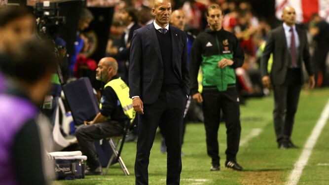 Zidane sigue atento una jugada del Rayo-Real Madrid con Paco Jémez al fondo.