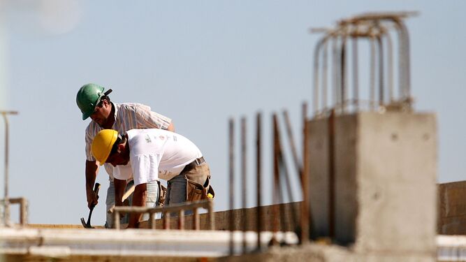 Dos trabajadores de la construcción en plena faena.
