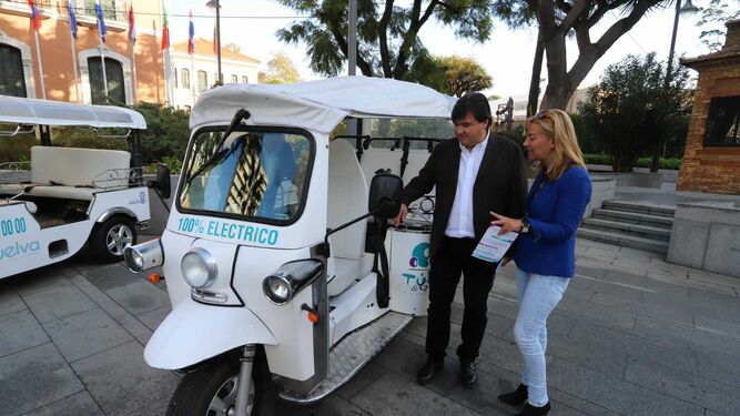 El alcalde de Huelva, Gabriel Cruz, junto a uno de los vehículos eléctricos.