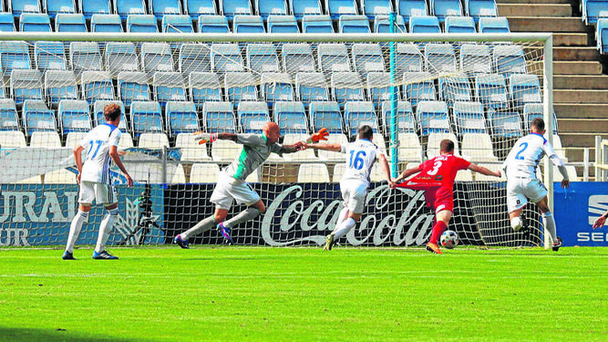 Cera agarra a un jugador de El Ejido en el lance que supuso el penalti a favor del cuadro almeriense en el Nuevo Colombino.