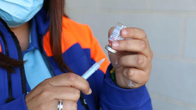 Una sanitaria carga una jeringuilla para administrar la vacuna contra la covid-19