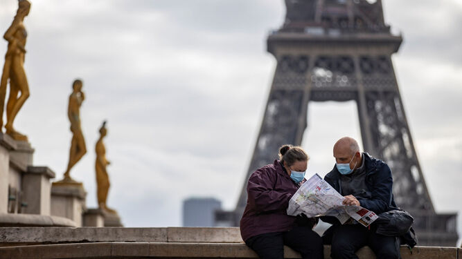 Turistas con mascarillas en París.