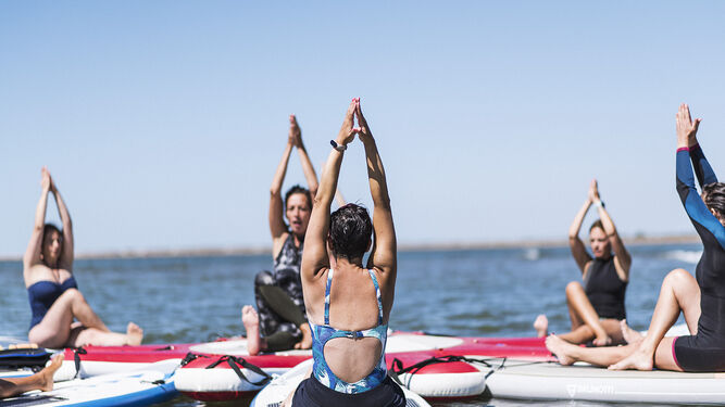 Una clase de yoga sobre el agua en una de las mejores playas de Huelva