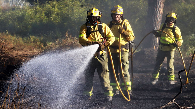 Bomberos trabajan en la extinción de un incendio en la provincia de Huelva.