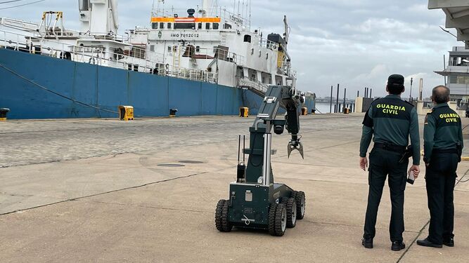 Dos agentes y el robot en el Muelle de Levante del Puerto de Huelva.