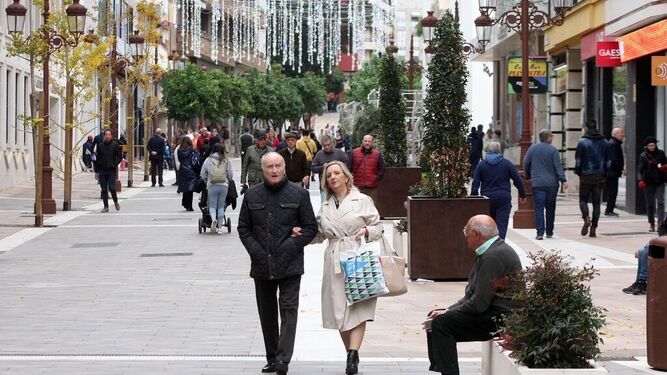 Una pareja pasea por una céntrica calle de Huelva
