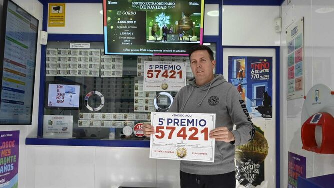 Curro Mendoza, lotero de la Administración La Merced muestra el número premiado