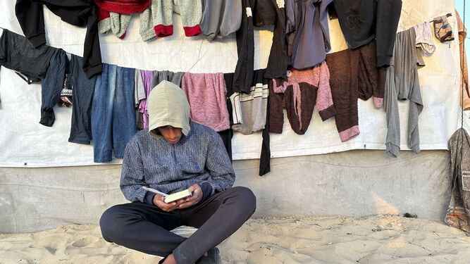 Un joven lee el Corán en Rafah.